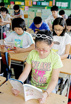 아침 독서 10분 운동으로 책읽기 삼매경에 빠져 있는 대구 동성초교생들과 도서관 도우미로 봉사하며 아침 독서 10분 운동에 활기를 불어넣고 있는 
