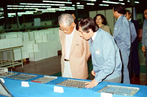 1982년 5월 삼성전자 구미공장을 둘러보는 호암. 삼성전자 구미공장은 교환기 국산화를 통해 우리나라 전화적체 현상을 일시에 해소한 것은 물론 반도체와 통신을 결합해내는 방법으로 세계적인 휴대전화 생산기지로 떠올랐다.