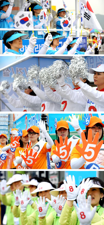 6·2지방선거가 일주일 앞으로 다가오면서 각 후보 선거운동원의 활동이 열기를 더해가고 있다. 25일 대구 달성군 현풍시장 입구에서 선거운동원들이 다양한 색상의 티셔츠와 소품을 들고 음악에 맞춰 율동을 하고 있다. 이채근기자 mincho@msnet.co.kr
