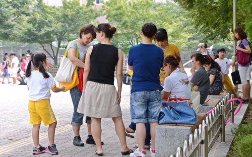 아동 성범죄가 잇따라 발생하면서 학부모들이 불안해하고 있다. 3일 대구시 달서구의 한 초등학교 정문에서 엄마들이 자녀들을 안전하게 귀가시키려고 삼삼오오 모여서 기다리고 있다. 정운철기자 woon@msnet.co.kr