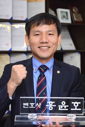 지역 로스쿨 1기생 중 개업 1호 변호사인 홍윤호 씨가 대구법원 앞 사무실에서 명패를 들고 환하게 웃고 있다. 정운철기자 woon@msnet.co.kr