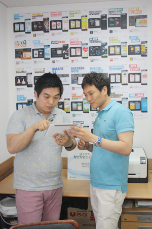 제이코프 안재희(오른쪽) 씨와 한 직원이 태블릿PC로 자사가 개발한 애플리케이션을 사용해보고 있다.