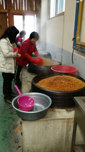 신서윤 대표와 직원들이 명품된장을 만들기 위해 가마솥에 부석태를 삶고 있다. 마경대기자
