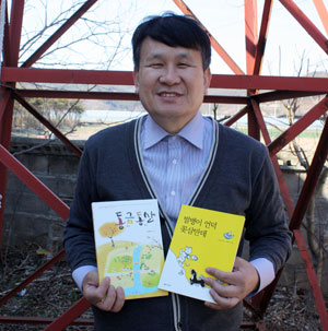 이창식 일직교회 목사가 아동문학가 권정생 선생이 생전 예배를 알리기 위해 친 교회 종 앞에서 동화책을 무료로 나눠주고 있다. 전종훈 기자