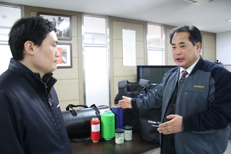 (주)부성텍스텍은 패션용 가방 직물 전문 기업으로 시작해 산업용 및 고기능성 가방을 개발하는 데 성공, 가방직물 업계의 혁신을 이끌고 있다. 부성텍스텍 채철수 상무이사가 한국섬유개발연구원 관계자와 개발 성과를 논의하고 있다. 홍준헌 기자