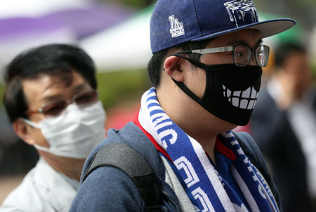 미세먼지가 전국을 뒤덮은 6일 오후 축구 경기를 위해 수원월드컵경기장을 찾은 시민들이 마스크를 쓰고 있다. 연합뉴스