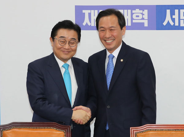 우상호(오른쪽) 더불어민주당 원내대표가 15일 오전 국회 원내대표회의실에서 전병헌 청와대 정무수석과 악수하고 있다. 연합뉴스