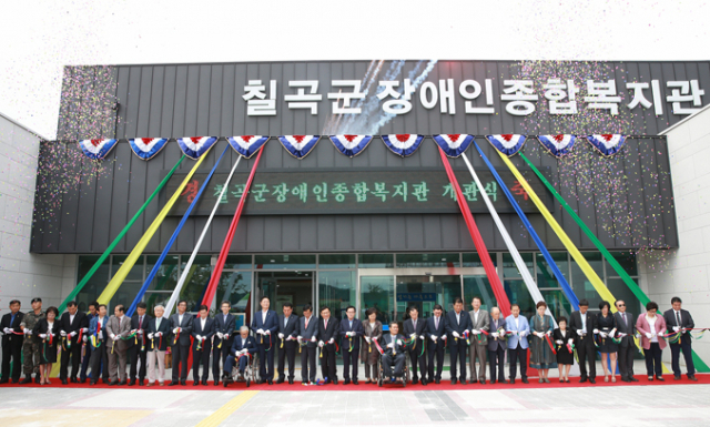 칠곡군장애인종합복지관 개관식 참가자들이 개관 테이프를 자르고 있다. 칠곡장애인복지관은 칠곡군 장애인들의 복지 수준을 한 단계 끌어올리는 것은 물론, 칠곡군 장애인 정책의 패러다임이 바뀌는 시금석이 될 것으로 평가된다. 칠곡군 제공
