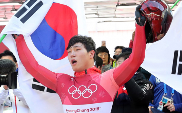16일 강원도 평창군 슬라이딩센터에서 열린 남자 스켈레톤 경기에서 금메달을 따낸 대한민국 윤성빈이 태극기를 들고 관중에게 인사하고 있다. 연합뉴스