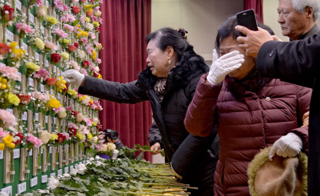 18일 오전 대구도시철도공사 강당에서 열린 대구지하철 중앙로역 화재 참사 15주기 추모식에서 유가족들이 헌화하며 오열하고 있다. 김영진 기자 kyjmaeil@msnet.co.kr