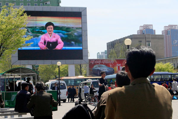북한이 핵실험과 장거리 미사일 발사를 중단한다는 아나운서의 발표를 북한 주민들이 21일 평양 시내에 설치된 대형 TV화면으로 시청하고 있다. 연합뉴스