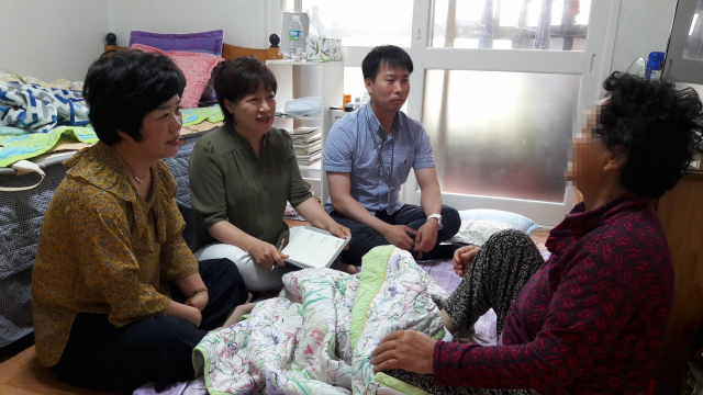 서명화(왼쪽에서 두 번째) 왜관읍 맞춤형복지담당과 직원들이 왜관읍의 한 독거노인(맨 오른쪽) 가구를 찾아 지원할 수 있는 서비스에 대해 상담하고 있다. 이현주 기자