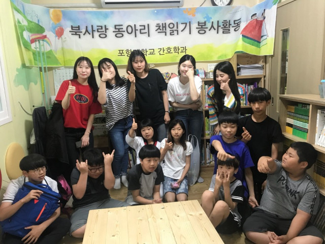 포항대 북사랑 동아리가 포항 북구 양학동 지역 아동센터에서 책읽기 봉사활동을 마치고 기념촬영을 하고 있다. 포항대 제공