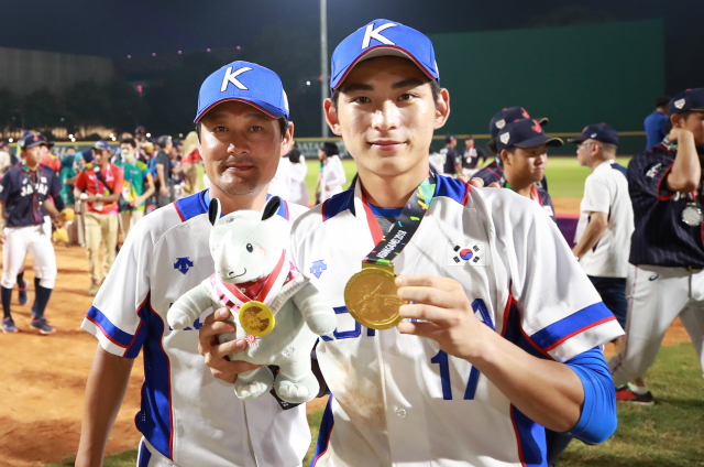 1일 오후 (현지시간) 인도네시아 자카르타 겔로라 붕 카르노(GBK) 야구장에서 열린 2018 자카르타-팔렘방 아시안게임 결승 한국과 일본의 경기에서 3-0으로 승리하며 우승을 차지한 한국 이정후와 이정후의 아버지 이종범 주루코치가 금메달을 들고 기념촬영을 하고 있다. 연합뉴스
