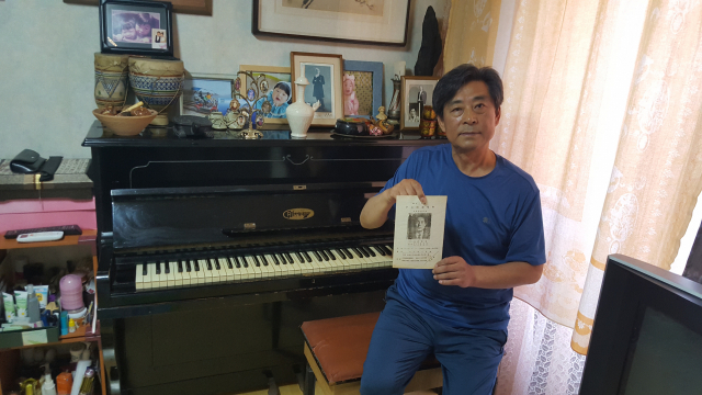 대구 원로음악인 고 이점희 영남대 교수의 아들 재원 씨가 피아노를 비롯한 이 교수의 유품에 대해 설명하고 있다. 재원 씨가 들고 있는 서류는 1955년 매일신문 주최 