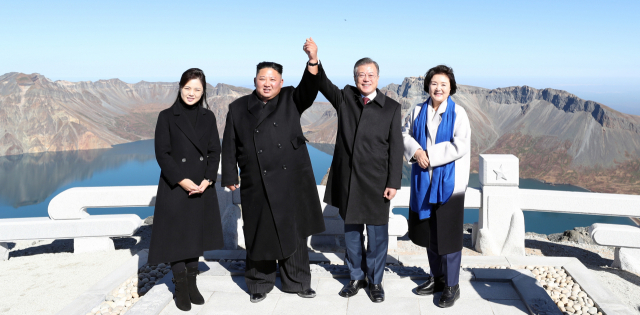 김정은 북한 국무위원장은 대대적인 리모델링 공사가 진행 중인 양강도 삼지연군 건설현장을 올해 들어 세 번째 시찰했다고 북한 매체들이 30일 보도했다. 사진은 조선중앙TV가 공개한 것으로, 김 위원장이 폭설을 맞으며 최룡해 노동당 부위원장(사진 맨왼쪽) 등 수행원 및 건설현장 관계자로 보이는 인사들과 대화하는 모습. [국내에서만 사용가능. 재배포 금지. For Use Only in the Republic of Korea. No Redistribution] 연합뉴스