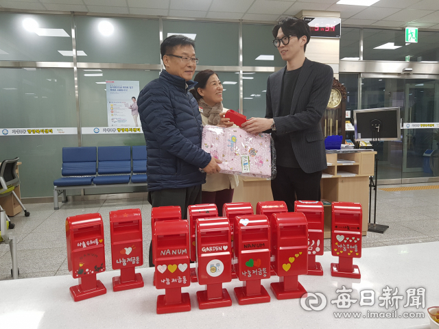 임태진 가흥1동 동장이 산부 전재현 씨에게 나눔저금통과 인견이불을 선물하고 있다. 마경대 기자