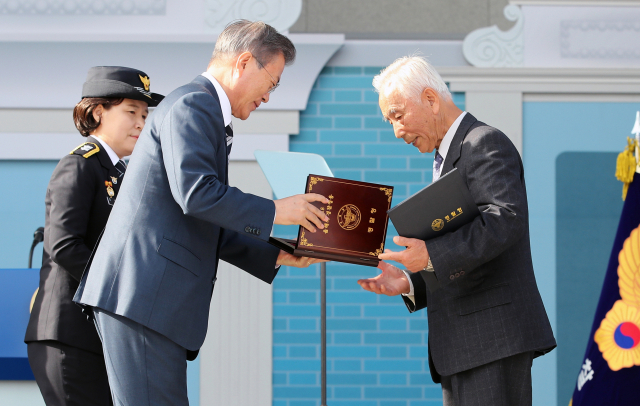문재인 대통령이 25일 오후 서울 용산구 백범기념관에서 열린 제73주년 경찰의 날 기념식에서 올해의 경찰 영웅에 