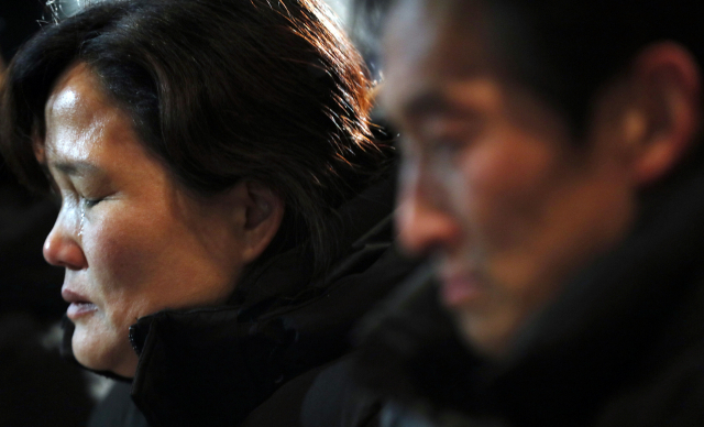 충남 태안화력에서 사고로 숨진 비정규직 노동자 고(故) 김용균 씨의 장례 이튿날인 8일 오후 서울 종로구 서울대병원 장례식장 앞에서 열린 추모 촛불문화제에서 고인의 어머니 김미숙 씨가 추모시를 들으며 눈물을 흘리고 있다. 연합뉴스