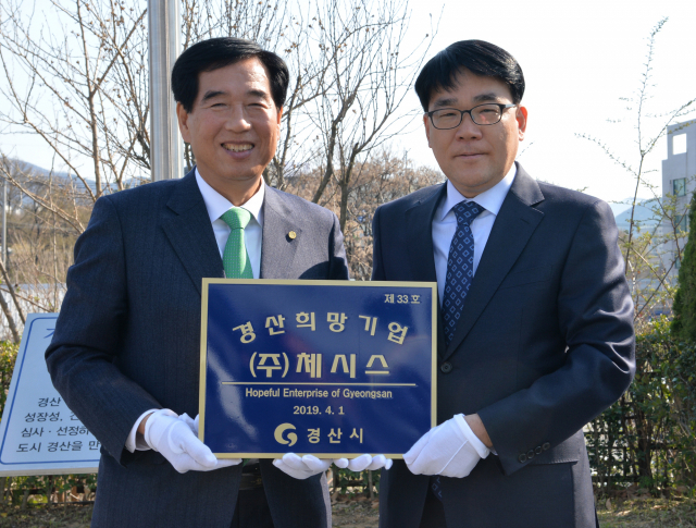 2019년 2분기 경산 희망기업으로 선정된 (주)체시스의 김성광 대표(오른쪽)가 최영조 경산시장으로부터 현판을 전달받고 있다. 경산시 제공