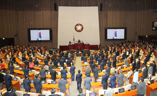 지난달 7일 오후 국회 본회의장에서 열린 제367회 임시회 개회식에서 참석자들이 국기에 경례하고 있다. 연합뉴스