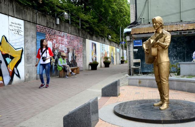 공작 수컷이 날개를 활짝 펴 암컷에게 구애하고 있다. 뒤에서 남녀커플이 신기한 듯 지켜보고 있다. 이채근 기자 mincho@imaeil.com