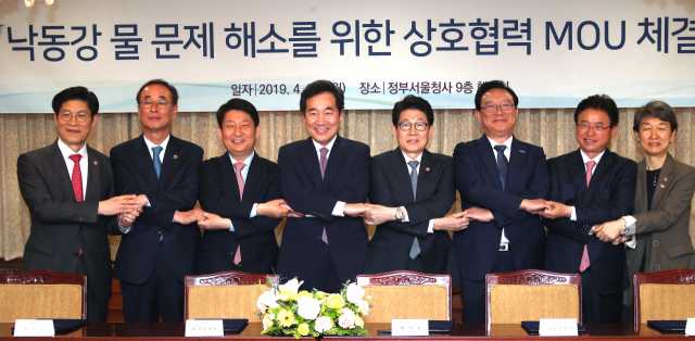 이낙연 국무총리가 29일 정부서울청사에서 낙동강 물 문제 해소를 위한 업무협약 체결식에 참석해 기념 촬영을 하고 있다. 왼쪽부터 노형욱 국무조정실장, 장세용 구미시장, 권영진 대구시장, 이 총리, 조명래 환경부 장관, 송철호 울산시장, 이철우 경북도지사, 정재숙 문화재청장. 연합뉴스