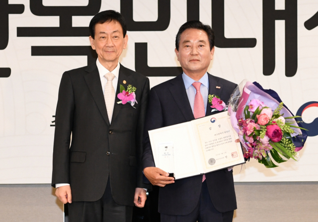 21일 올해 다산목민대상을 수상한 김문오 달성군수가 시상식 자리에서 진영 행정안전부 장관으로부터 축하를 받고 있다.