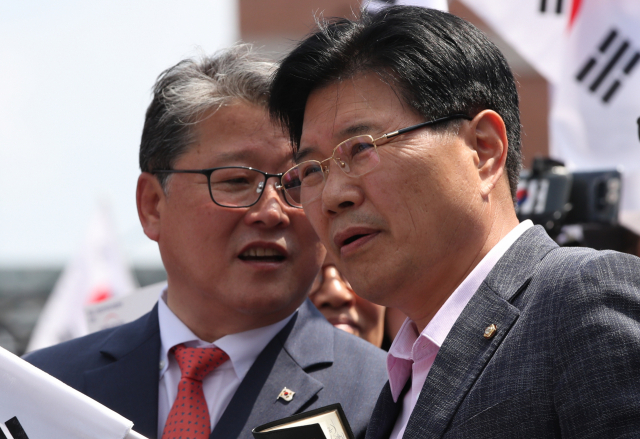 자유한국당 홍문종(오른쪽) 의원이 15일 오후 서울역 광장에서 열린 태극기집회에 참석, 조원진 대한애국당 대표와 대화하고 있다. 이 자리에서 탈당 선언을 한 홍문종 의원은 대한애국당 공동대표로 추대됐다. 연합뉴스