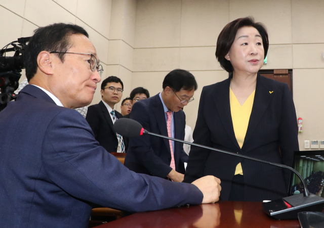 29일 오전 준연동형 비례대표제 도입을 골자로 공직선거법 개정안을 심의하는 국회 정치개혁특별위원회 전체회의에서 더불어민주당 소속 홍영표 위원장과 정의당 심상정 의원이 인사한 뒤 회의장을 바라보고 있다. 연합뉴스