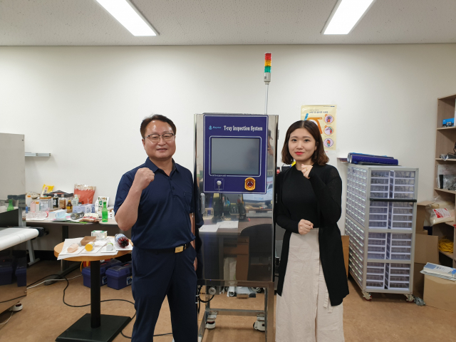 신문식 레이텍 대표(왼쪽)가 직원과 함께 T-레이 검사기를 소개하고 있다. 박상구 기자
