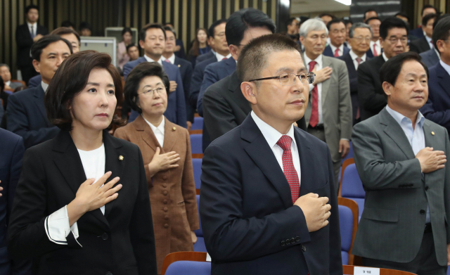 자유한국당 황교안 대표, 나경원 원내대표와 의원들이 22일 국회에서 열린 의원총회에서 국기에 대한 경례를 하고 있다. 연합뉴스