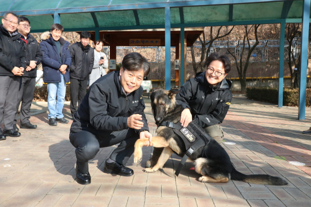24일 대구경찰청에서 열린 체취증거견 계급 수여식에서 최용석 대구경찰청 과학수사과장(왼쪽)과 체취증거견 핸들러 안성현 경장이 탕고의 계급장을 보이고 있다. 대구경찰청 제공.
