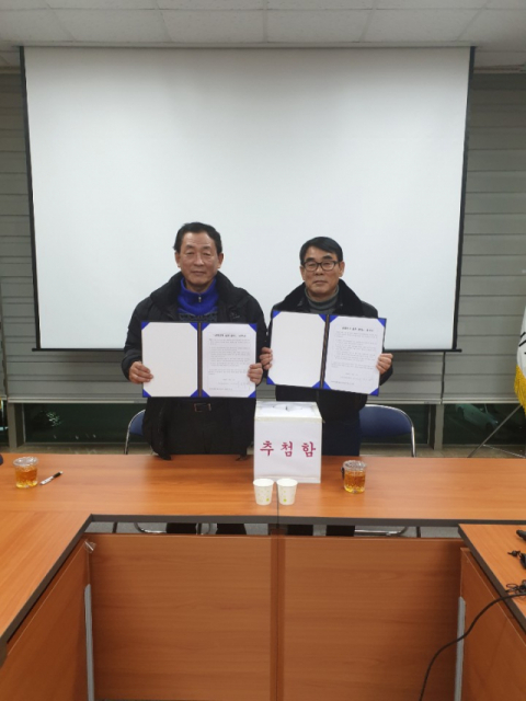 김천시체육회장 후보자로 등록한 서정희(왼쪽), 최한동 후보가 서명한 공명선거 협약서를 들어보이고 있다. 김천시체육회장 선거관리위원회 제공