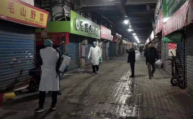 중국 보건당국이 원인불명 폐렴이 발생한 우한 수산시장에서 방역 작업을 하고 있다.