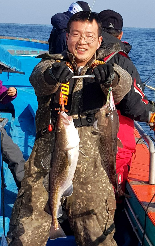 말봉 바다낚시 팀원이 잡아올린 대구를 들어보이고 있다.