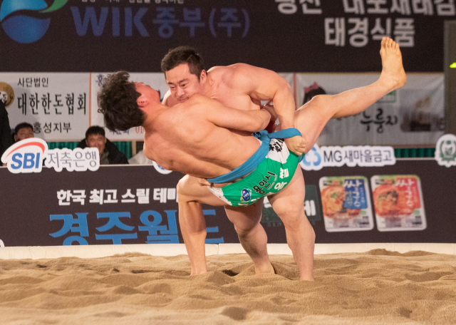23일 오후 충남 홍성군 홍성읍 홍주문화체육센터에서 열린 2020 홍성설날장사씨름대회 태백장사전에 출전한 의성군청 윤필재(홍샅바)가 용인백옥쌀 유환철 누르고 태백장사로 등극하고 있다. 연합뉴스