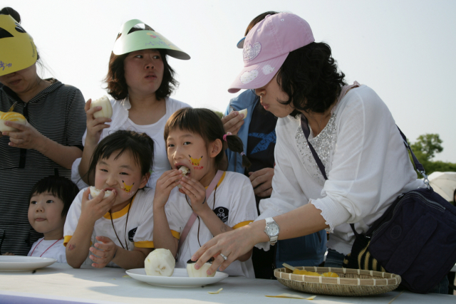 성주참외페스티벌에 참가한 엄마와 아이들이 성주참외를 먹고 있다. 성주참외에는 엽산이 풍부해 산모와 태아 건강에 도움을 준다. 성주군 제공