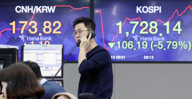 13일 서울 을지로 하나은행 본점 딜링룸에서 외환딜러들이 업무를 보고 있다. 이날 코스피는 유럽과 미국 증시가 10% 안팎 무너지는 등 글로벌 증시의 