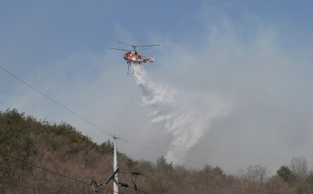 19일 오후 울산시 울주군 웅촌면 한 야산에서 불이 나 산림청 헬기가 물을 뿌리고 있다. 연합뉴스