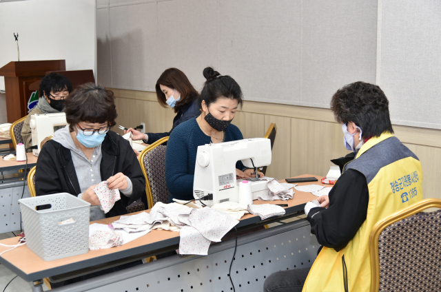 23일 청송군종합문화복지타운 실내집회장에서 청송군자원봉사센터 소속 자원봉사자들이 면 마스크를 만들고 있다. 청송군 제공