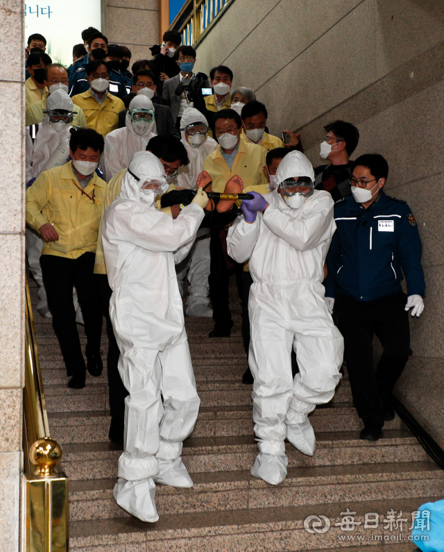 권영진 대구시장이 26일 오후 대구시청으로 출동한 119 구급대원에 의해 경북대병원으로 이송되고 있다. 권 시장은 앞서 코로나19 극복을 위한 원포인트 임시회가 끝난 뒤 본회의장을 나서던 중 갑자기 쓰러져 등에 업혀 시장실로 옮겨졌다. 우태욱 기자 woo@imaeil.com