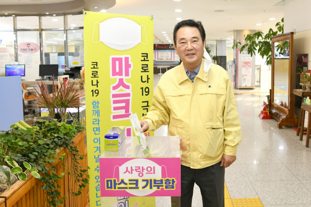 대구 달성군청에 마련된 마스크 기부함. 김문오 달성군수가 첫 번째로 마스크를 기부하고 있다. 김성우 기자