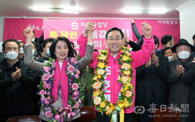 21대 총선 대구 수성갑에서 승리한 미래통합당 주호영 당선인이 15일 밤 선거사무실에서 부인 김선희(왼쪽)씨와 함께 꽃다발을 목에 걸고 환호하고 있다. 김태형 선임기자 thk@imaeil.com