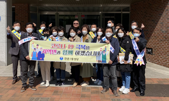 만촌1동성당 사목 상임위원, 레지오 간부, 구역장 등이 26일 범어동 야시공원에서 지역주민들에게 손 세정제를 나누어 주고 있다. 만촌1동성당 제공