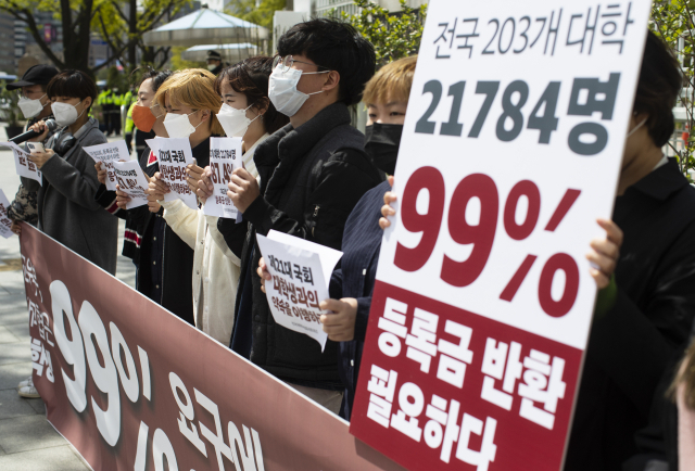 21일 정부서울청사 앞에서 열린 등록금 반환 및 대학생 경제대책 설문 조사 결과 전달 기자회견에서 전국대학학생네트워크 회원들이 등록금 반환 관련 내용이 적힌 손피켓을 들고 있다. 연합뉴스