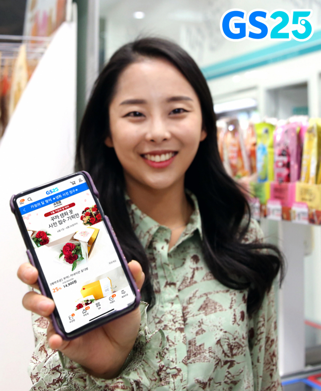 편의점 GS25가 어버이날을 앞두고 카네이션을 원하는 장소로 배송해주는 서비스를 시작한다고 최근 밝혔다. 사진은 모델이 GS25 전용앱 나만의 냉장고의 카네이션 구매 창을 내보이고 있다. [GS리테일 제공, 재판매 및 DB금지] 연합뉴스