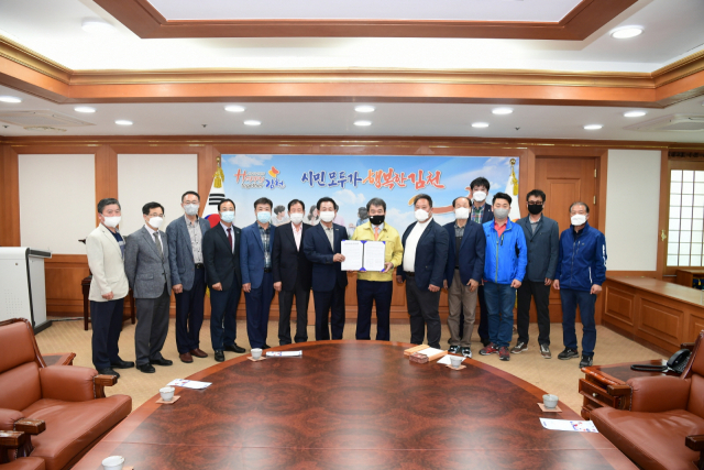 경북 김천시체육회와 상인회 대표 등은 13일 상무프로축구단 유치를 희망하는 건의문을 김충섭(가운데 오른쪽) 김천시장에게 전달하고 있다. 김천시 제공