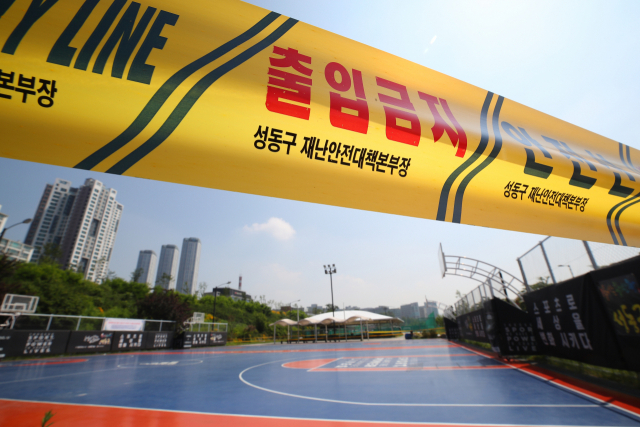 물류센터발 신종 코로나바이러스 감염증(코로나19) 확산 등으로 수도권 공공·다중시설 운영이 한시적으로 중단된 가운데 29일 오전 서울 성동구 응봉농구장 주위로 출입금지 선이 설치돼 있다. 연합뉴스