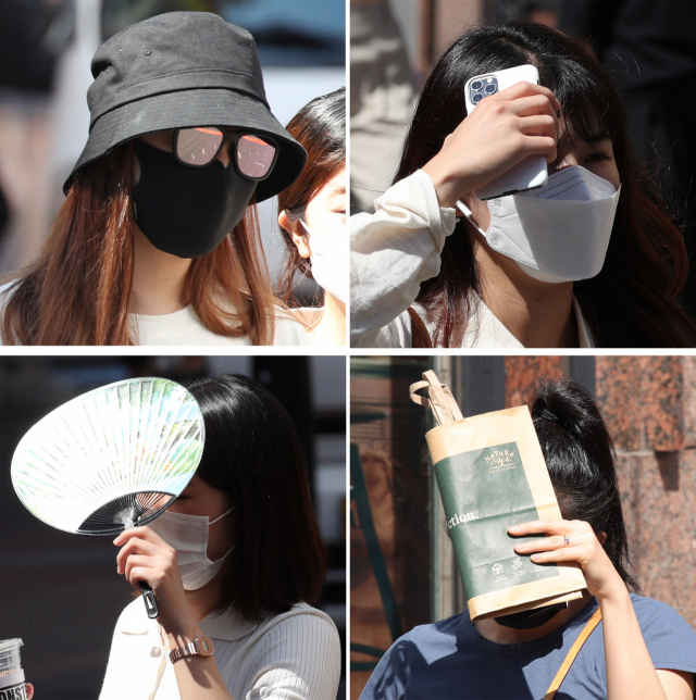 대구 중구 동성로에서 마스크를 쓴 채 가쁜 숨을 내쉬는 시민들이 선글라스와 휴대폰, 부채, 종이가방 등으로 내리쬐는 햇볕을 가리며 걷고 있다. 사진은 기사내용과 상관없음 매일신문DB